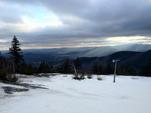 Snowy landscape with a blue signpost