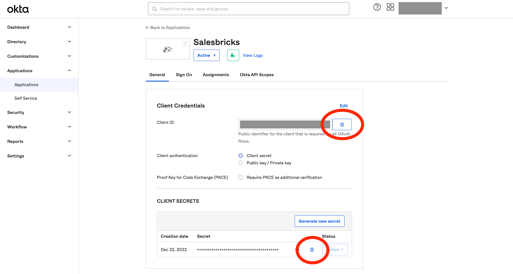 An image of the Okta admin dashboard. There are two red ovals: one around the clipboard icon that copies the client ID, and the other around the clipboard icon that copies the client secret.
