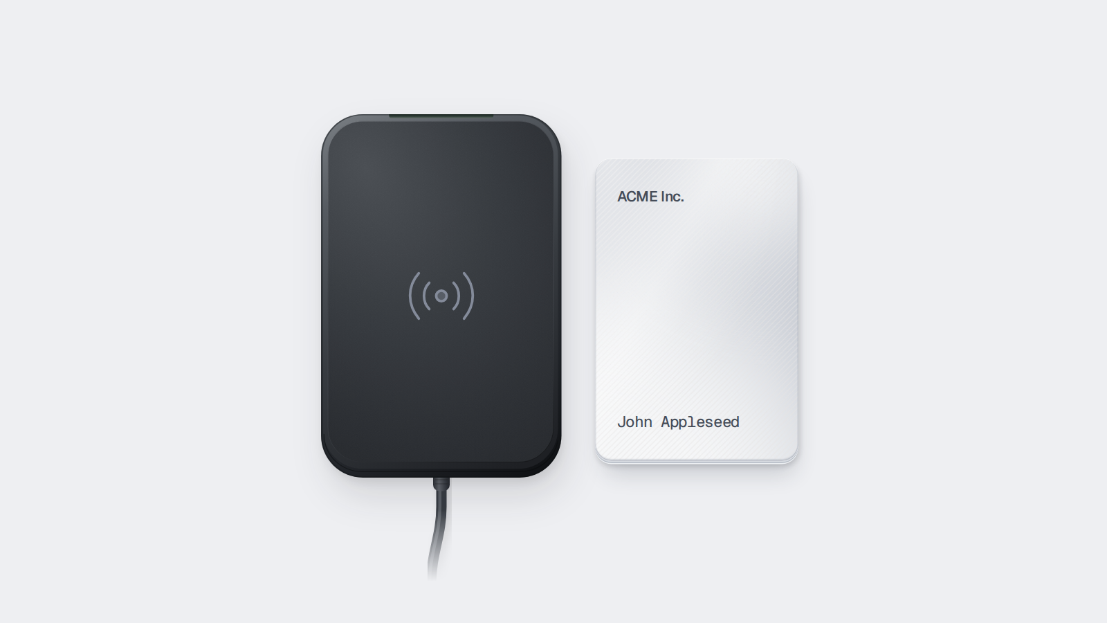 A plastic key card alongside a contactless card encoder.