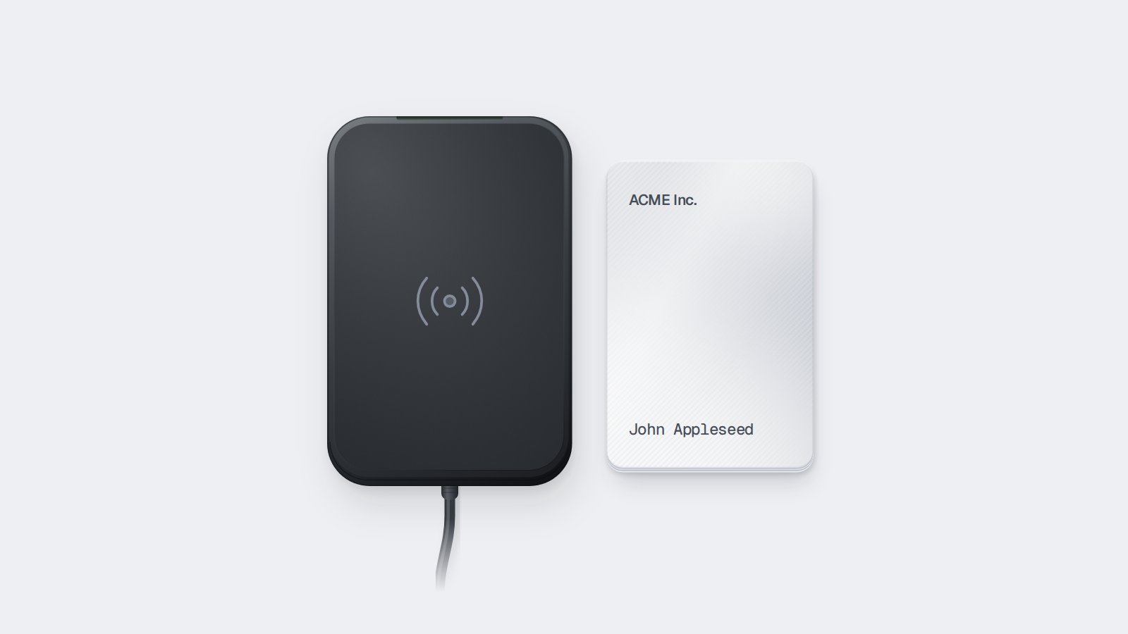 A plastic key card alongside a contactless card encoder.