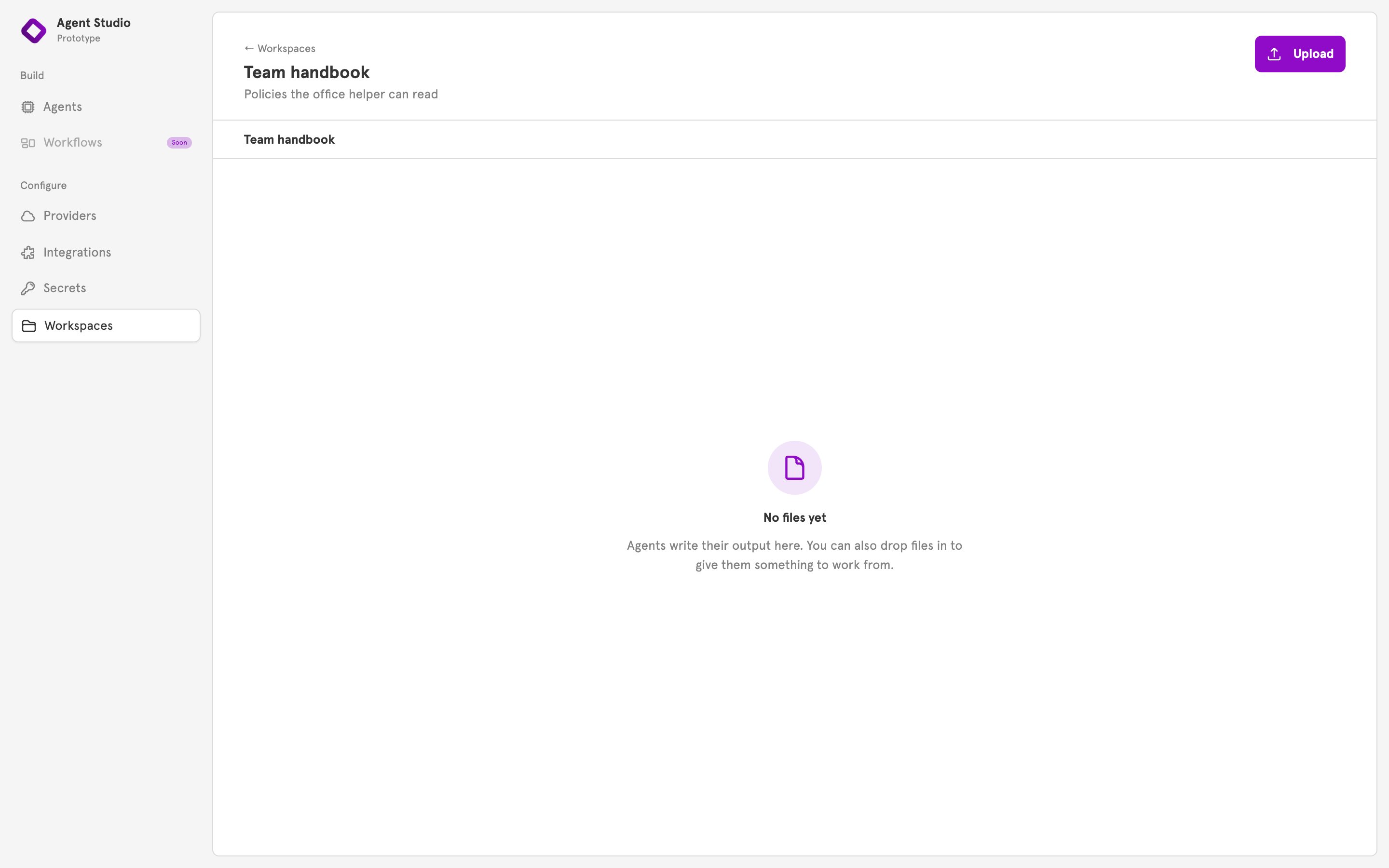 An empty workspace page with the Upload button