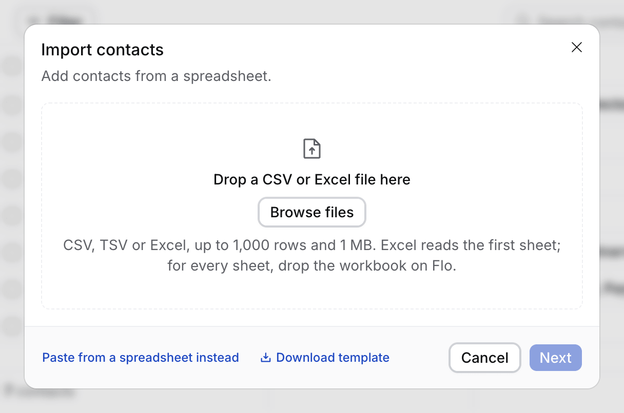 The first step of Import contacts: one drop zone, the file limits in one line, and the Paste from a spreadsheet instead and Download template links