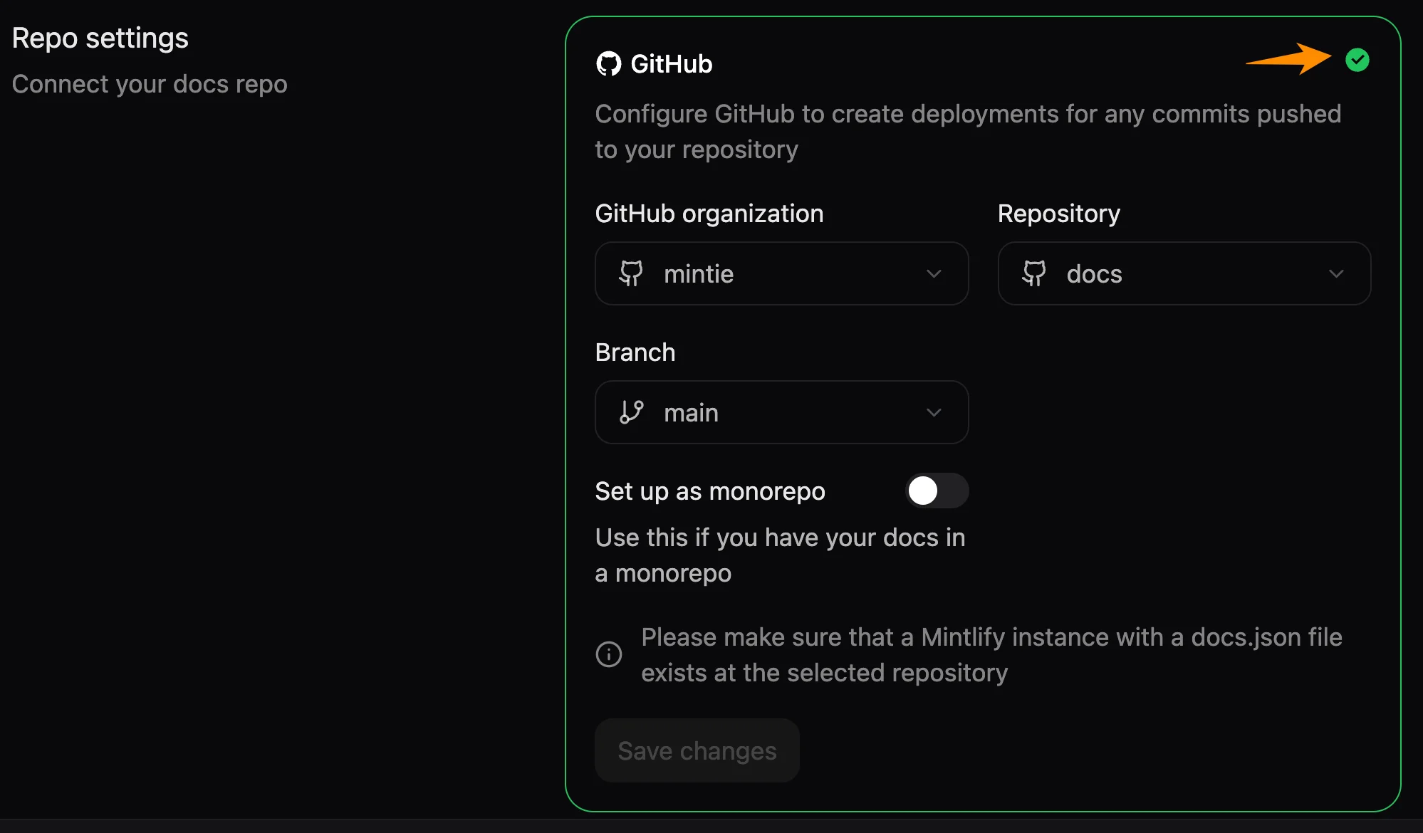The Git Settings page in the Mintlify dashboard. An orange arrow points to the green check mark that revalidates the repository settings.