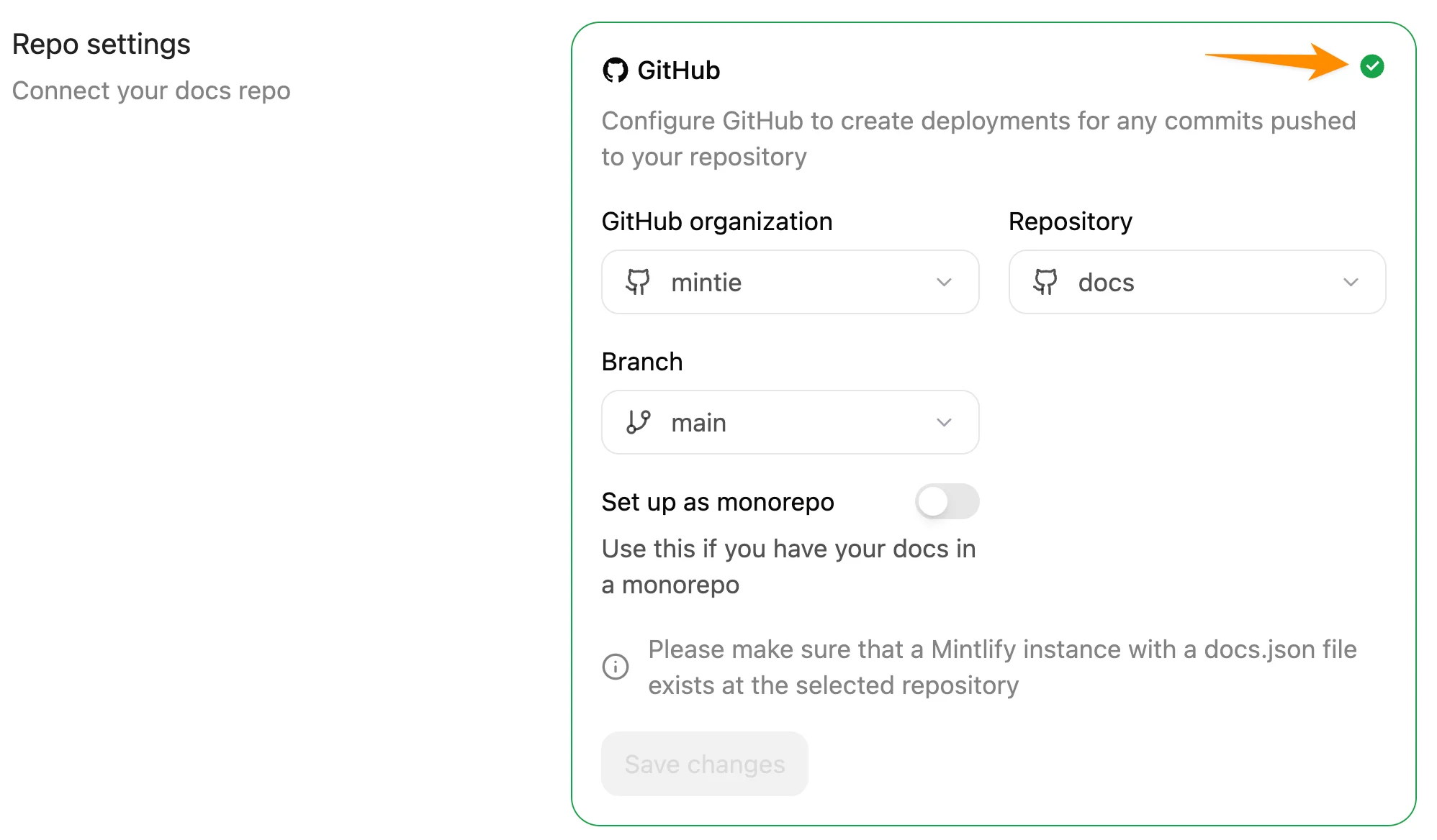 The Git Settings page in the Mintlify dashboard. An orange arrow points to the green check mark that revalidates the repository settings.