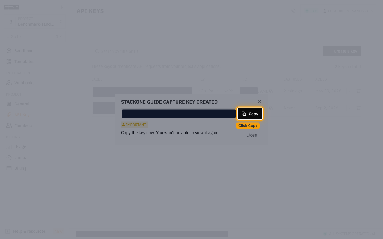 E2B key created dialog with the generated key redacted and the Copy button highlighted