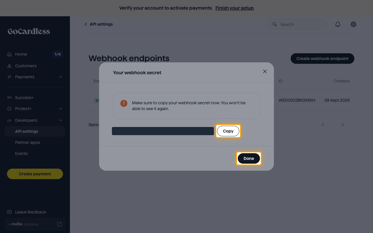 The Your webhook secret dialog with the secret value hidden and the Copy and Done buttons highlighted