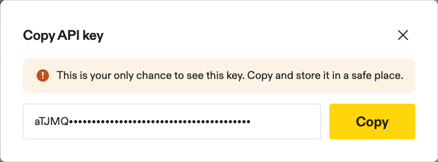 Copy API key modal with the masked key, a Copy button, and a close (X) button