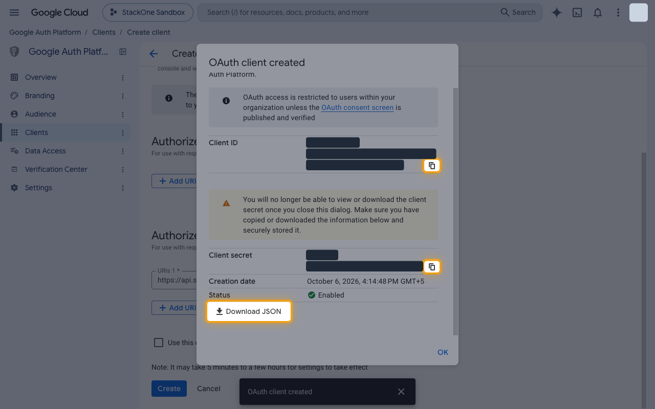 OAuth client created dialog with the Client ID and Client secret values hidden and the copy icons and Download JSON button highlighted