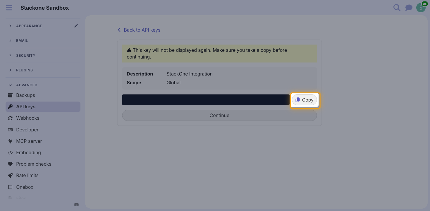 The generated API key screen with the key value hidden and the Copy button highlighted