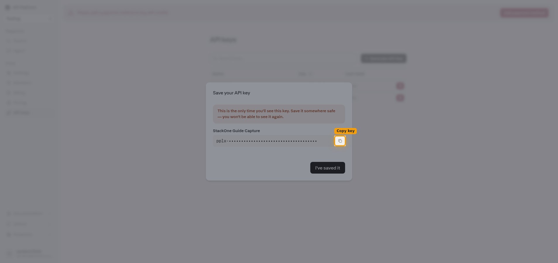 Save your API key screen with the one-time warning, the masked key, and the Copy key button highlighted