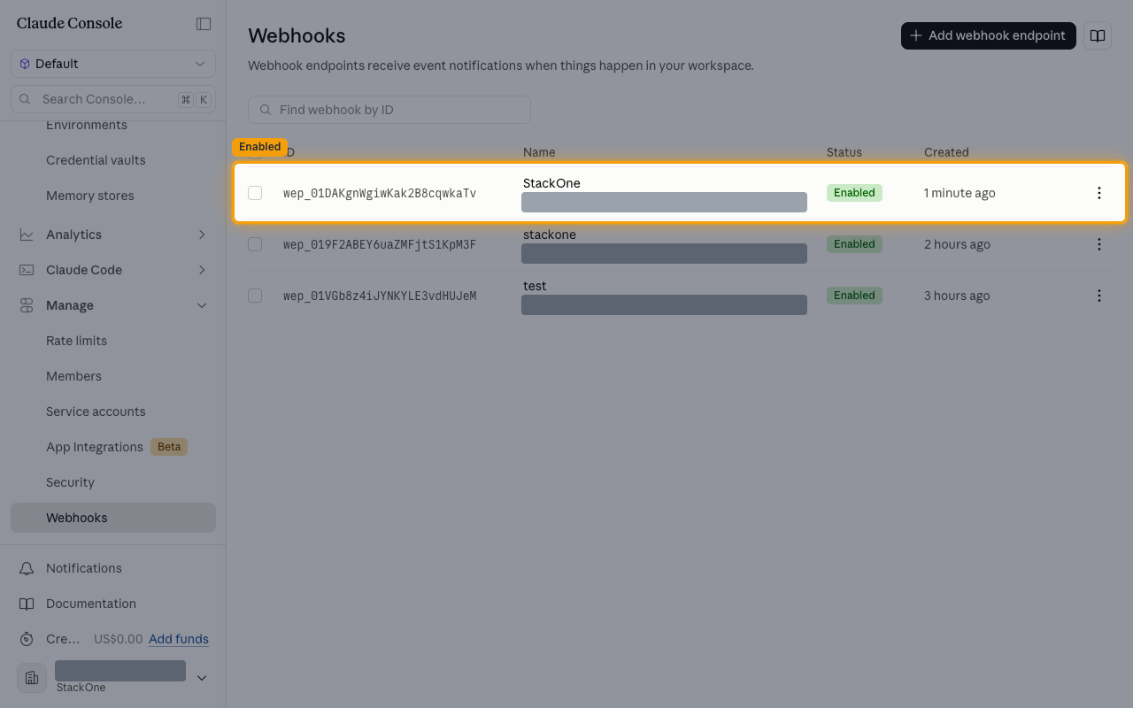 The Webhooks list showing the new endpoint with an Enabled status, its destination URL masked.