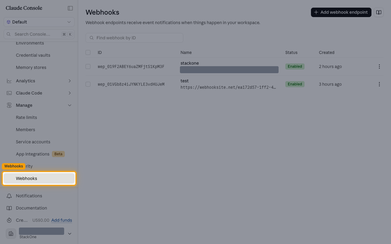 The Claude Console Webhooks page with the Webhooks entry under Manage highlighted in the sidebar.