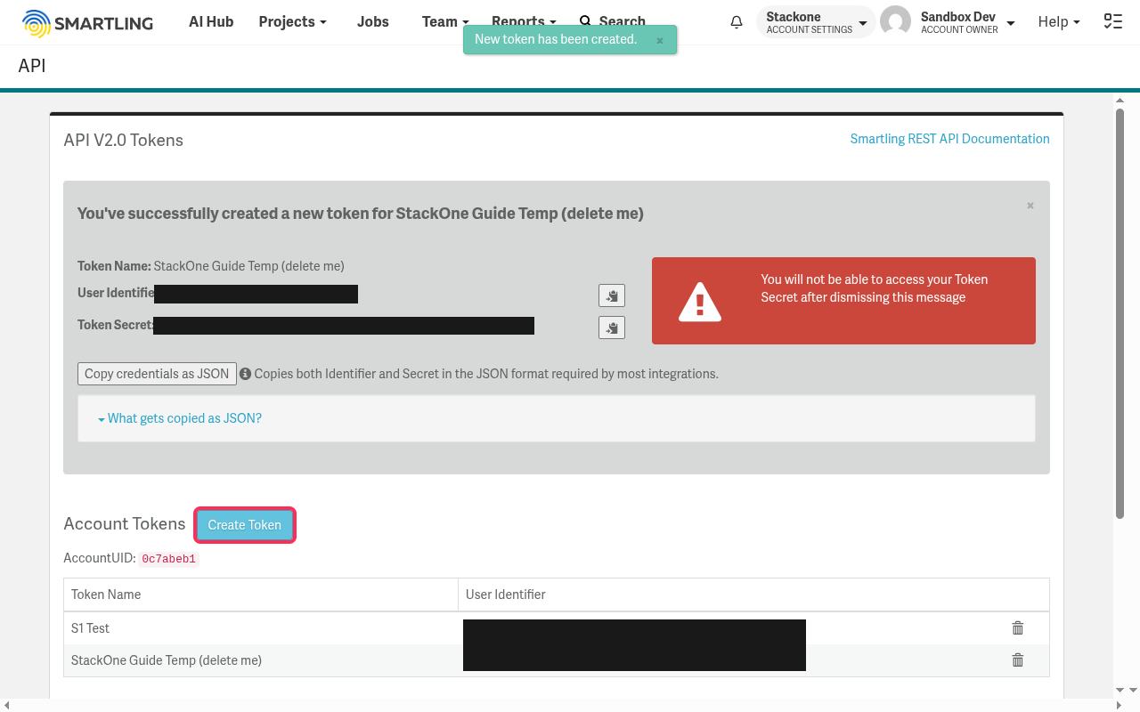 Token confirmation screen showing the User Identifier and Token Secret with copy buttons