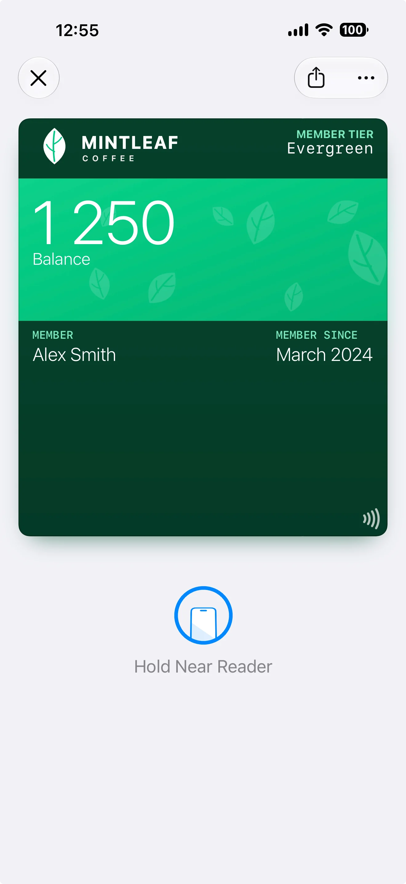 A pass with NFC enabled in Apple Wallet, showing a tap icon on the pass and the Hold Near Reader prompt below it
