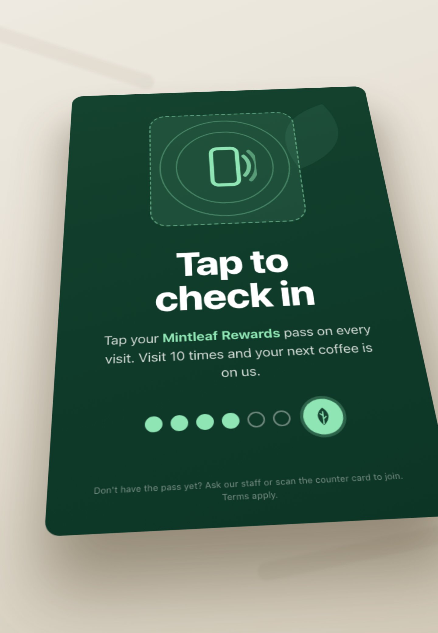 A flat Mintleaf Rewards tap-to-check-in mat on a counter, with a contactless tap zone, the headline Tap to check in, a visit-streak indicator, and the note visit ten times for a free coffee