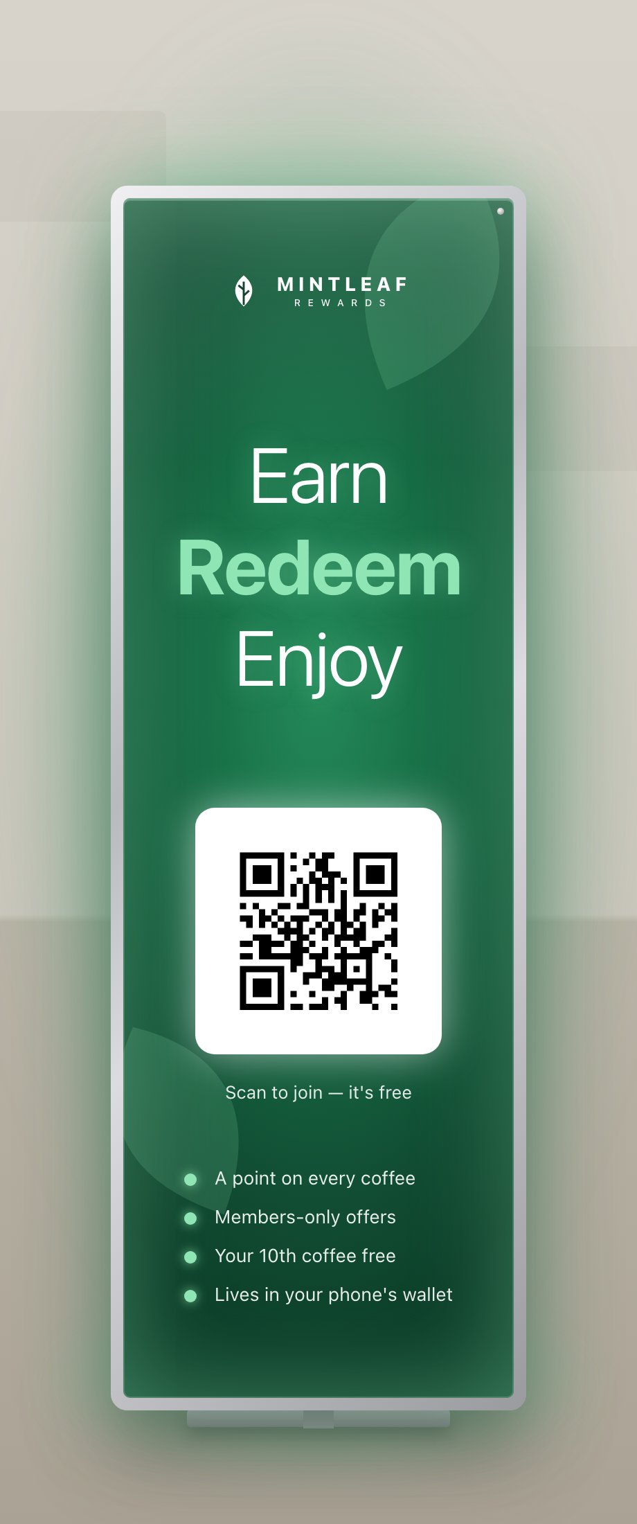 A tall, slim illuminated Mintleaf Rewards lightbox totem in an aluminium frame, lighting the floor around it, with the words Earn Redeem Enjoy, a glowing QR code, and a list of member perks