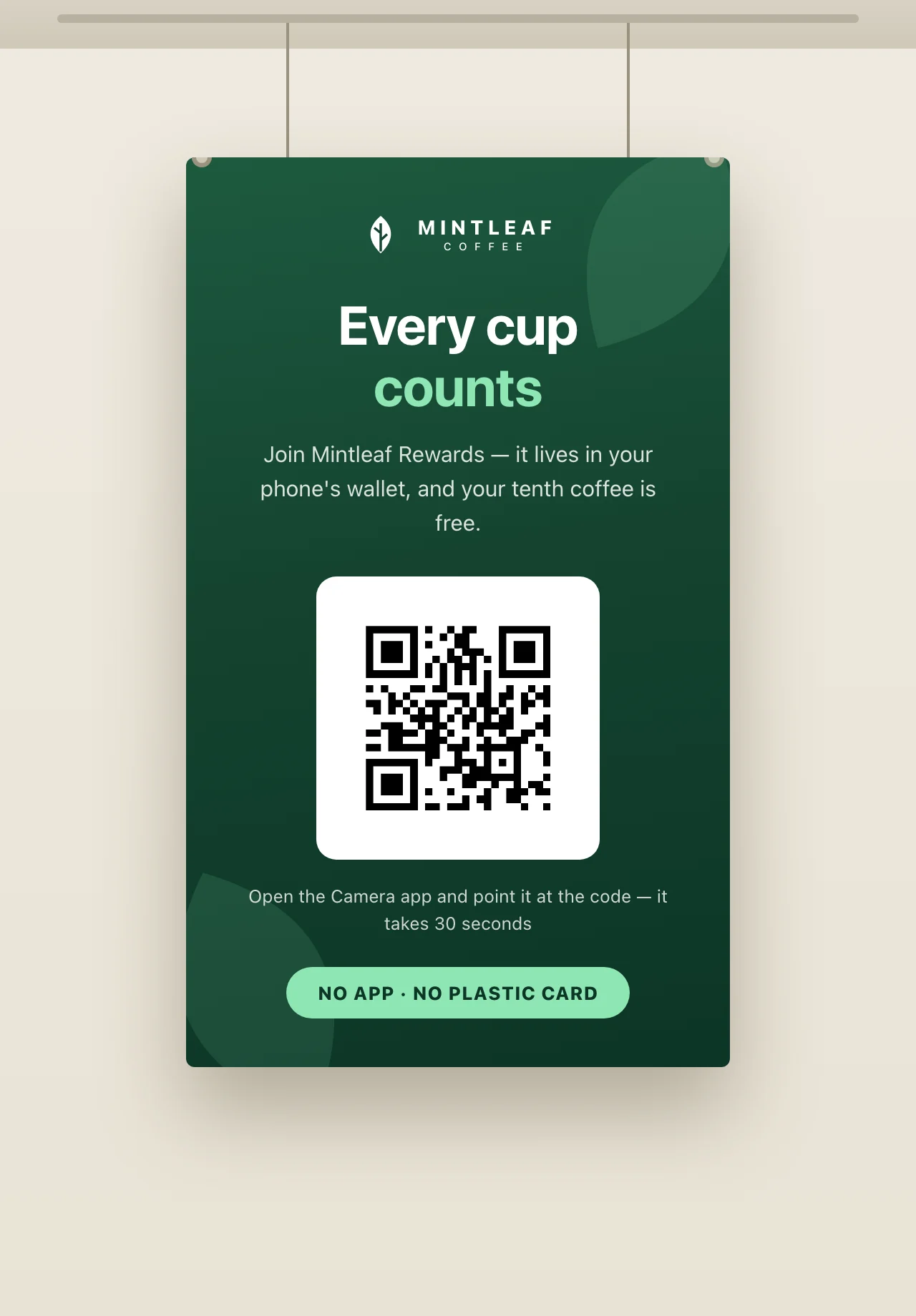 A Mintleaf Rewards banner hanging from the ceiling on two wires, with the headline Every cup counts, a QR code, and a scanning instruction