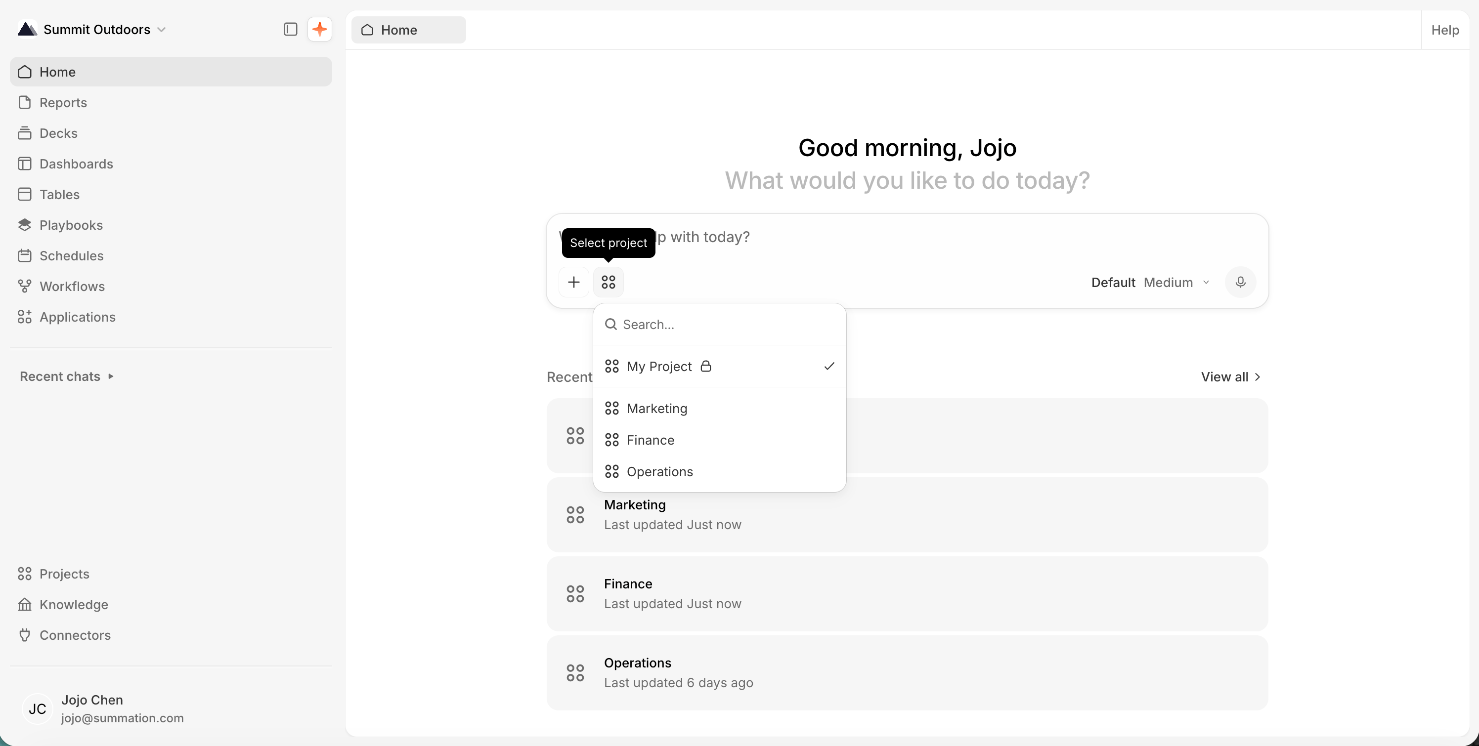 The Home page greeting 'Good morning, Jojo, What would you like to do today?' above the composer, with its project picker open: a searchable list showing 'My Project' checked, followed by 'Marketing', 'Finance', and 'Operations'. Recent projects are listed below the composer.