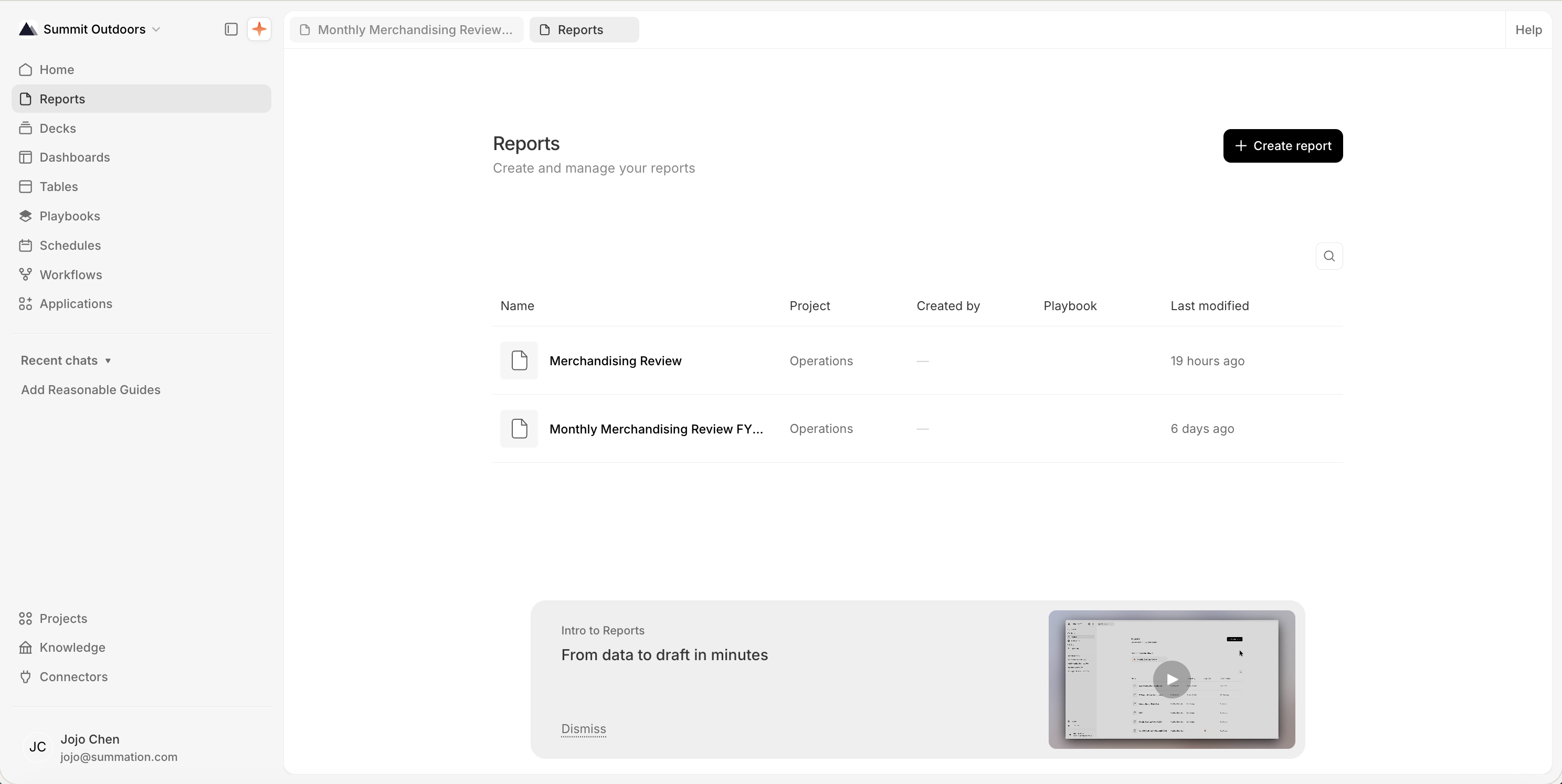 The Reports page at /report, titled 'Reports' with the subtitle 'Create and manage your reports' and a 'Create report' button at the top-right. A table lists two reports, 'Merchandising Review' and 'Monthly Merchandising Review FY...', both in the Operations project, with Created by, Playbook, and Last modified columns. An 'Intro to Reports: From data to draft in minutes' onboarding card with a video thumbnail and Dismiss link sits at the bottom.