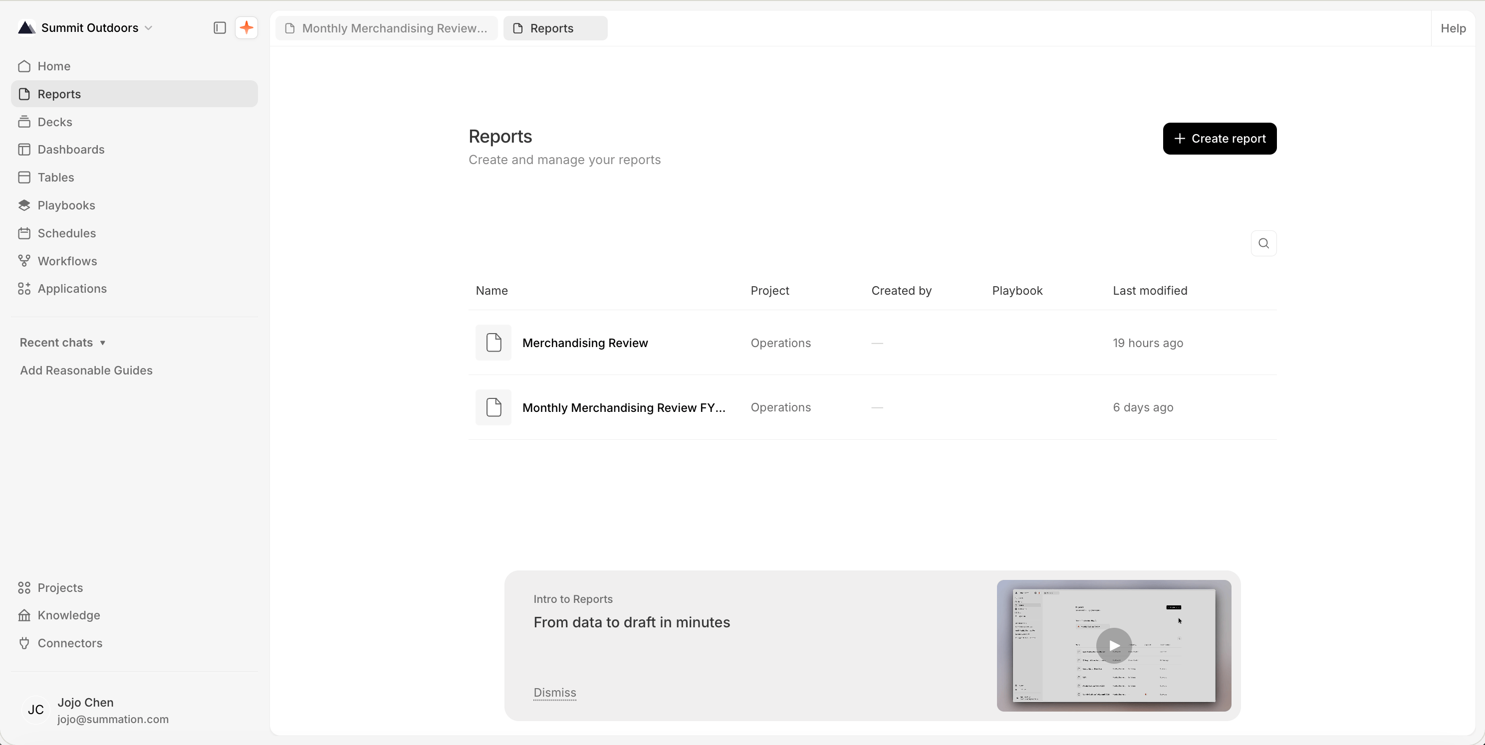 The Reports page at /report, titled 'Reports' with the subtitle 'Create and manage your reports' and a 'Create report' button at the top-right. A table lists two reports, 'Merchandising Review' and 'Monthly Merchandising Review FY...', both in the Operations project, with Created by, Playbook, and Last modified columns. An 'Intro to Reports: From data to draft in minutes' onboarding card with a video thumbnail and Dismiss link sits at the bottom.