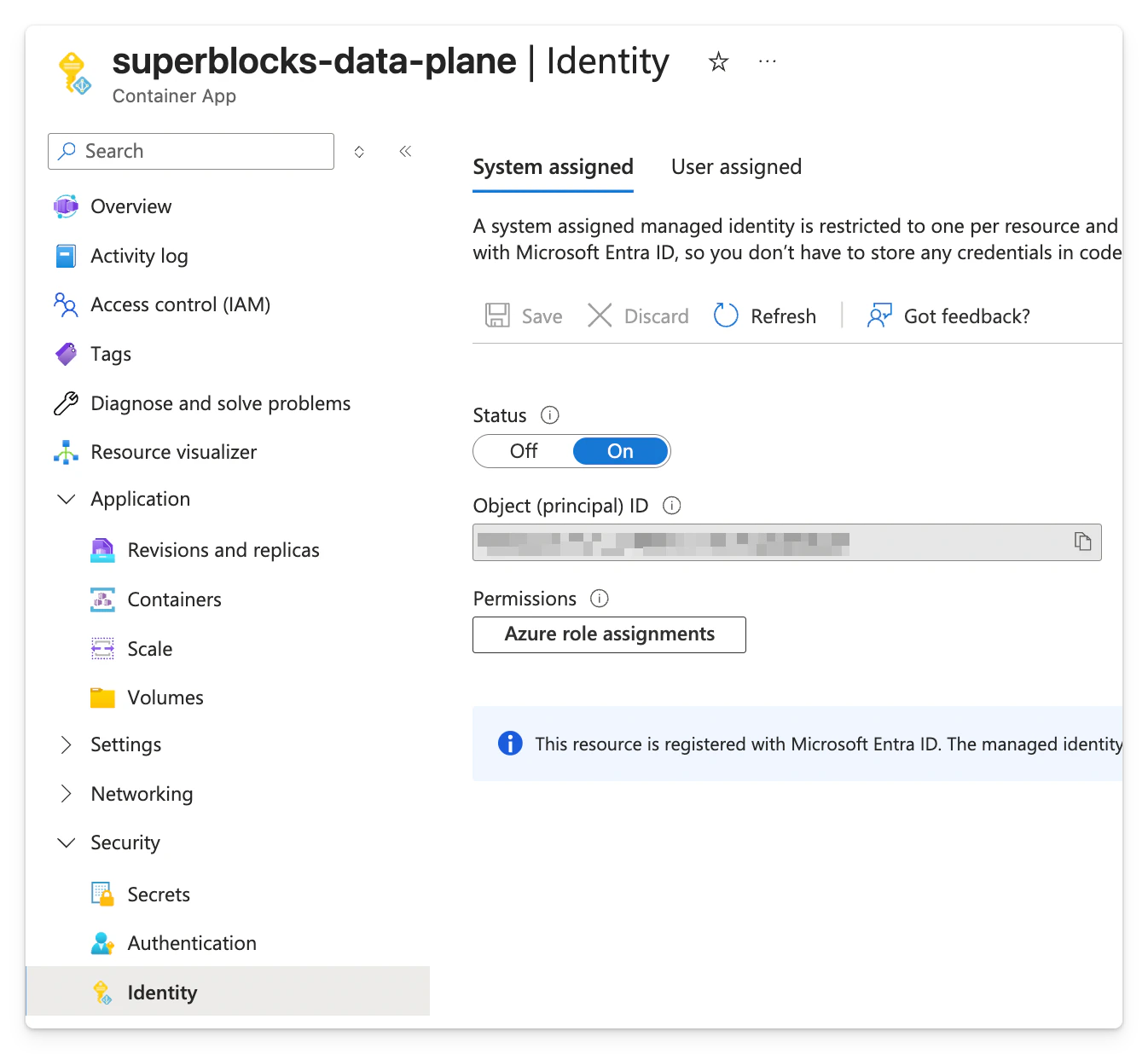 Azure Container App Identity page with System assigned tab selected and Status toggled On