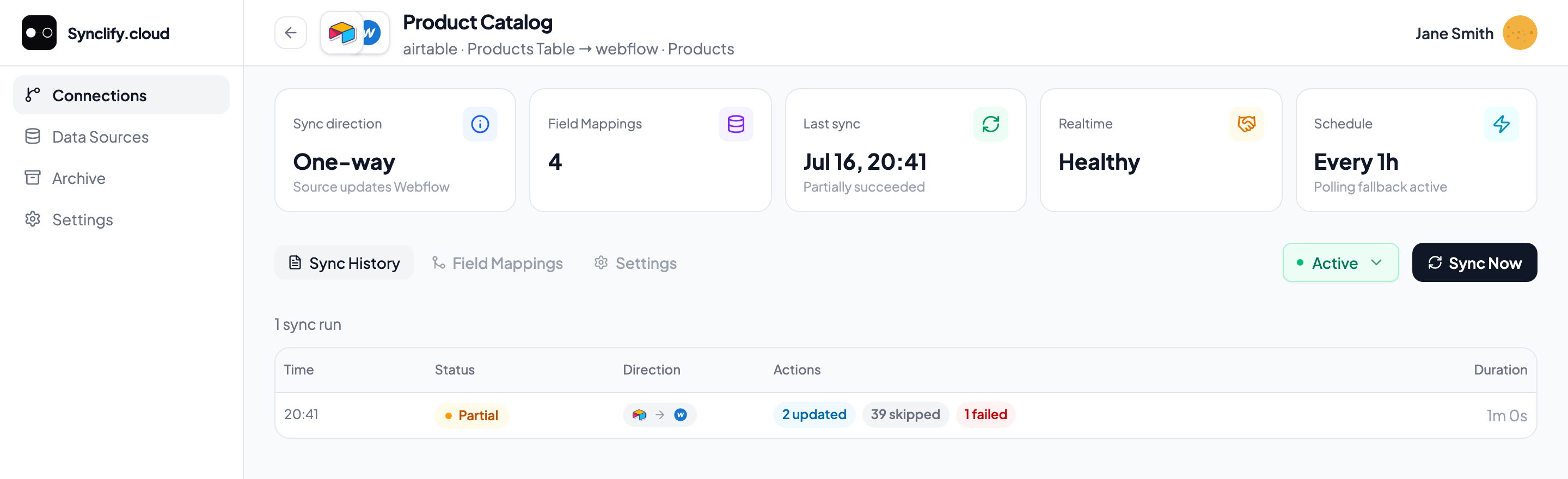 Sync History tab listing one run with a Partial status, its direction, action counts, and duration
