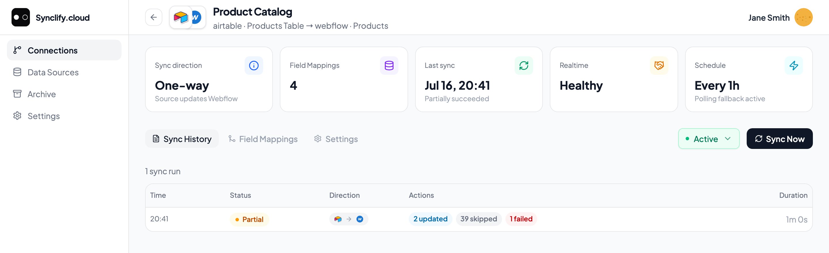 Sync History tab listing one run with a Partial status, its direction, action counts, and duration