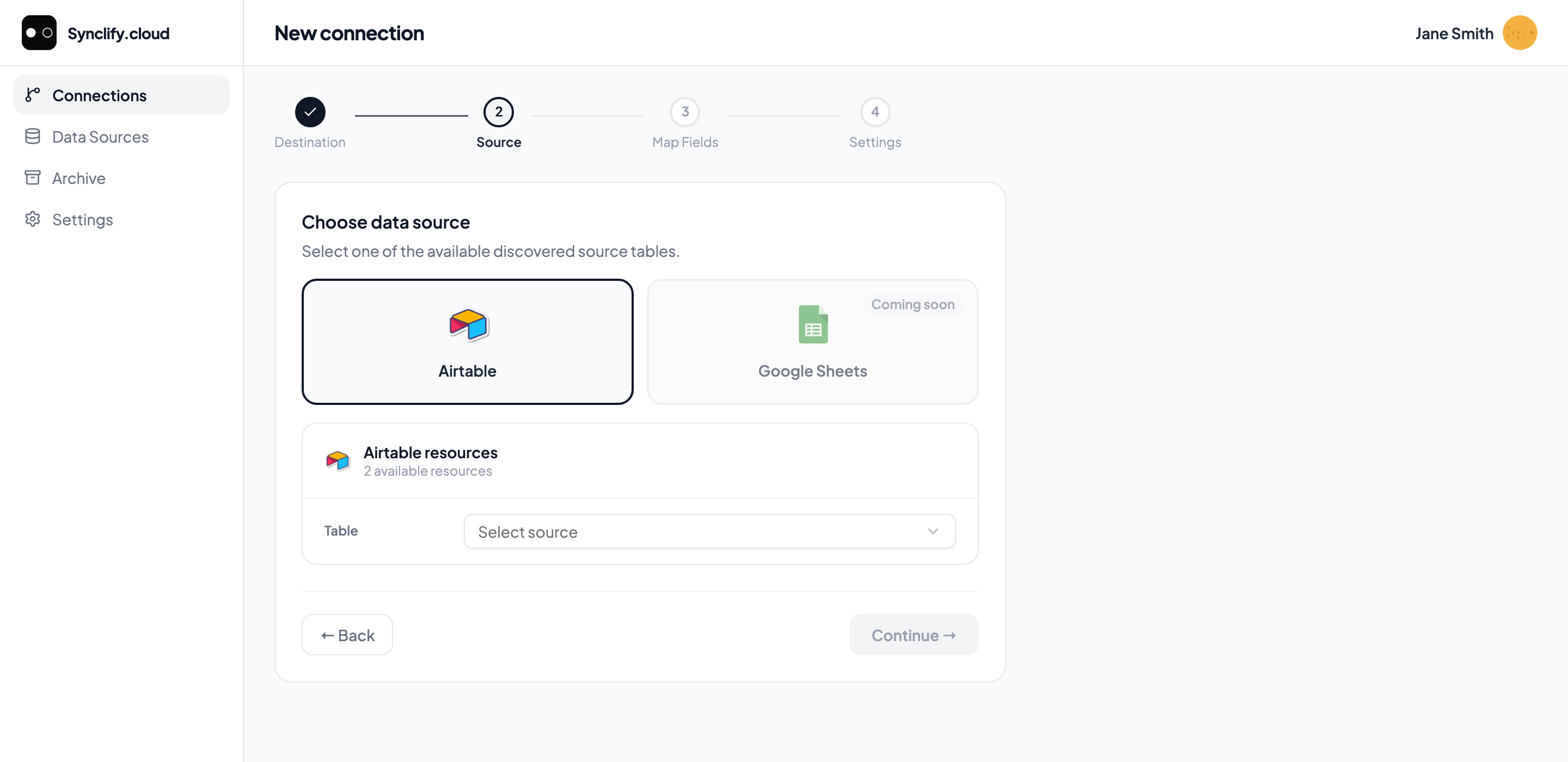Wizard step 2: Airtable selected as the source with a table dropdown; Google Sheets shown as Coming soon