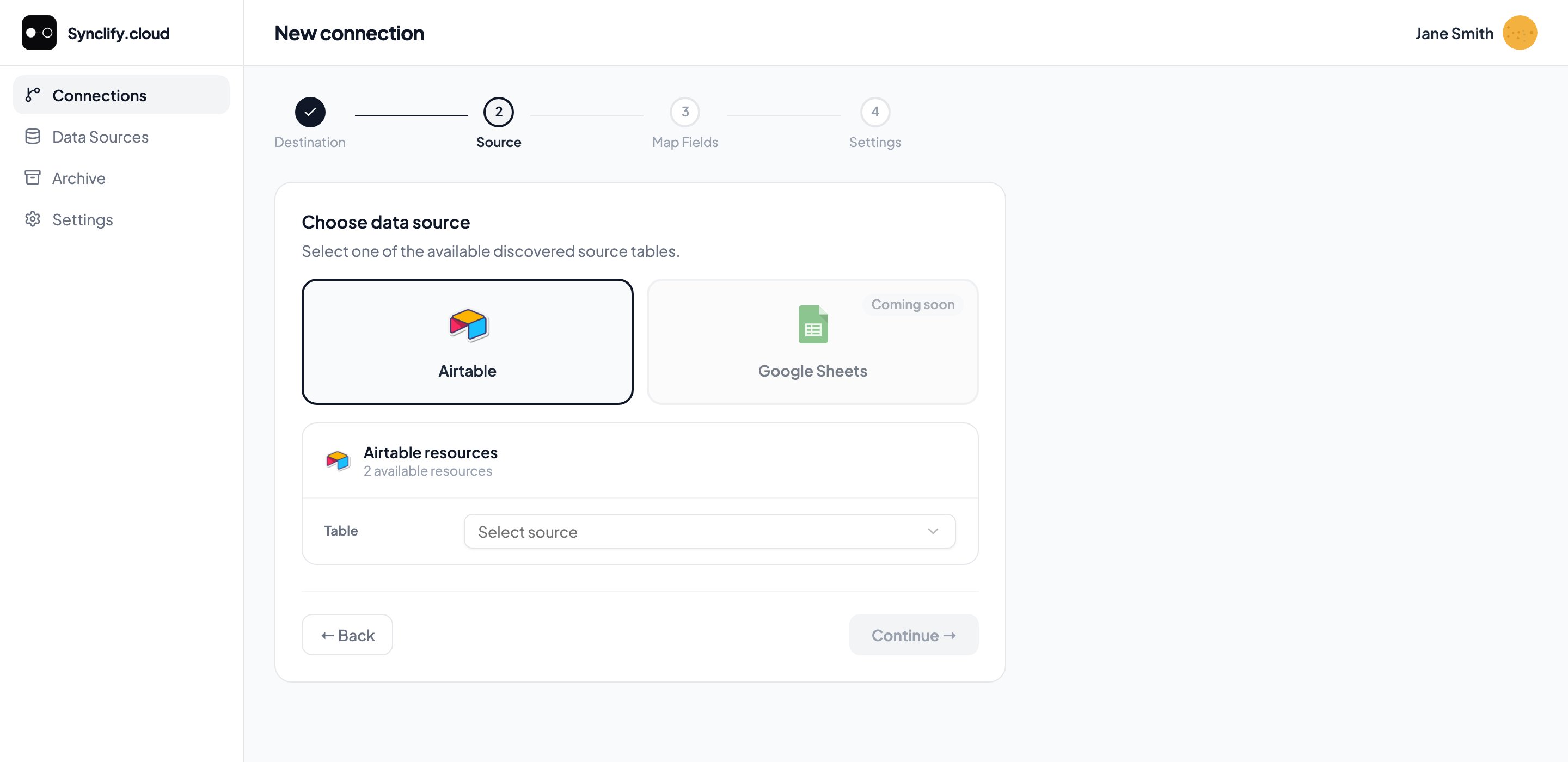 Wizard step 2: Airtable selected as the source with a table dropdown; Google Sheets shown as Coming soon