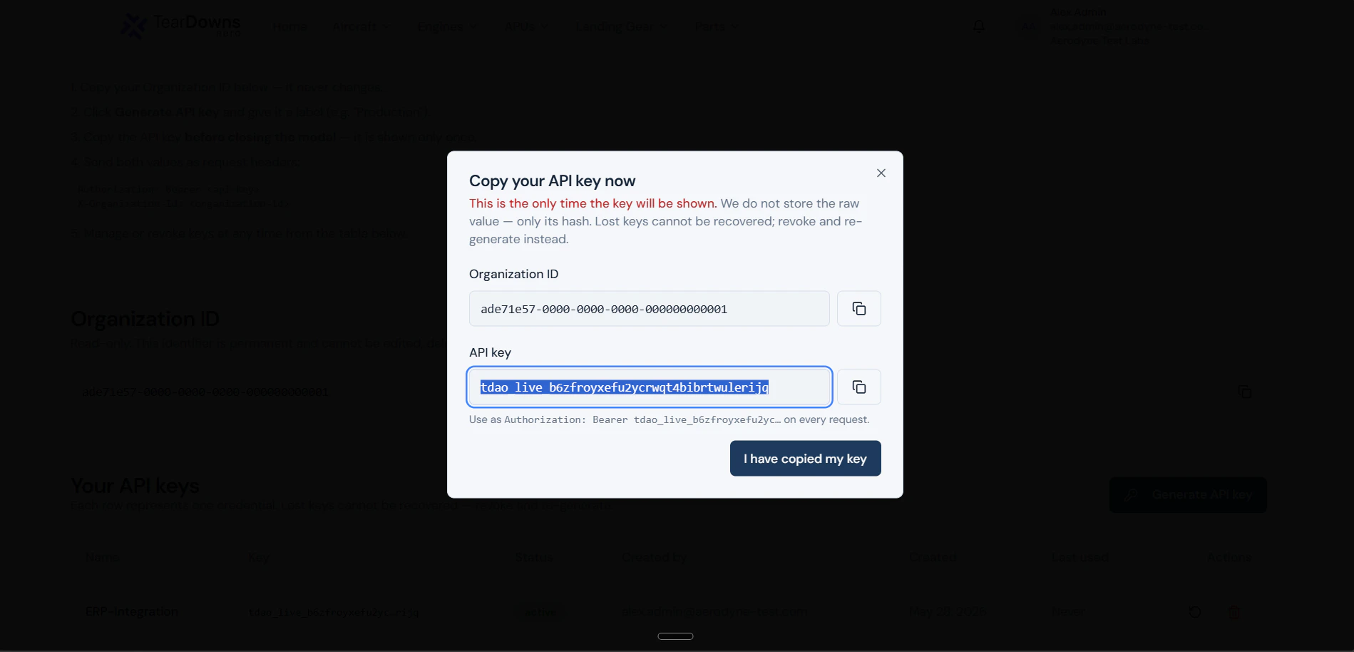 Secret-reveal pop-up showing the raw tdao_live_… value and the Organization ID with a copy banner