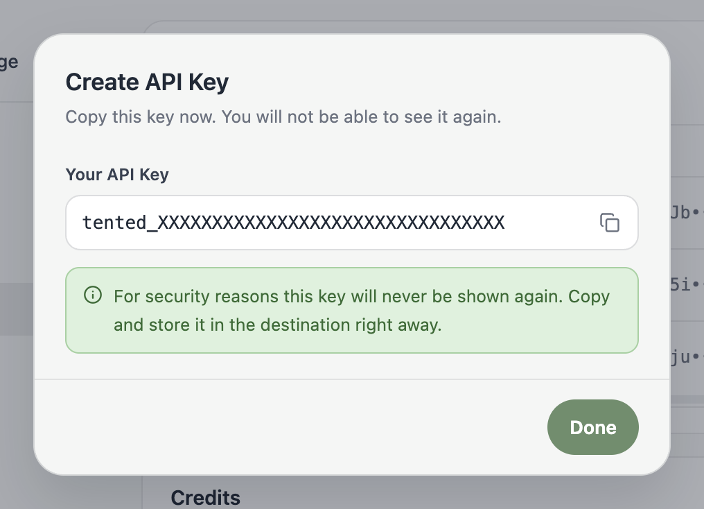 A screenshot of the Create API Key dialog showing a newly generated key and a warning that it won't be shown again.