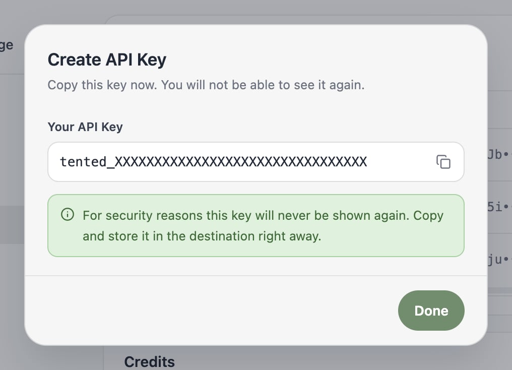 A screenshot of the Create API Key dialog showing a newly generated key and a warning that it won't be shown again.