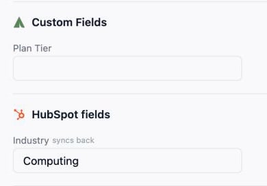 A contact in People with its HubSpot fields group; Industry is marked as syncing back.