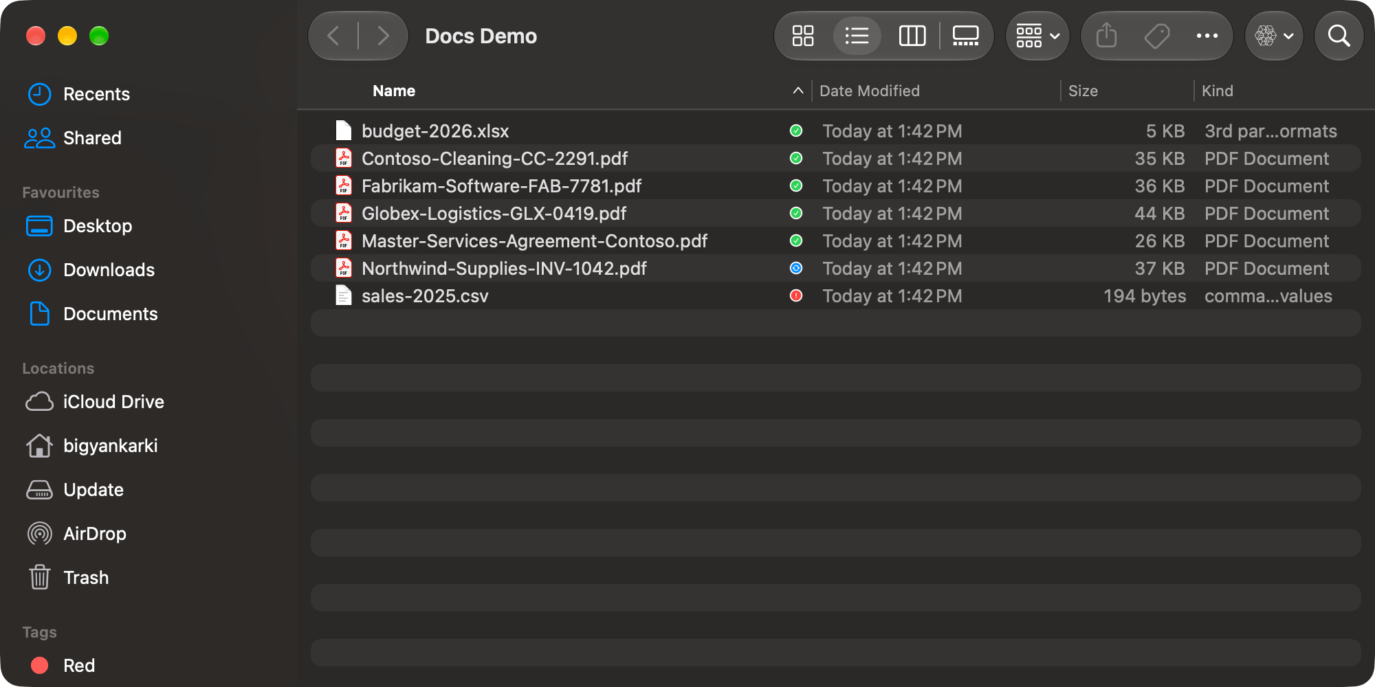 A synced folder in Finder with a green check next to most files, blue arrows next to one uploading and a red alert next to one that failed