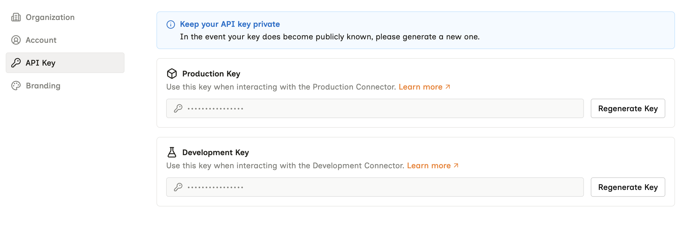 The API Key settings page, showing a Production Key block and a Development Key block, each with a masked value and a Regenerate Key button