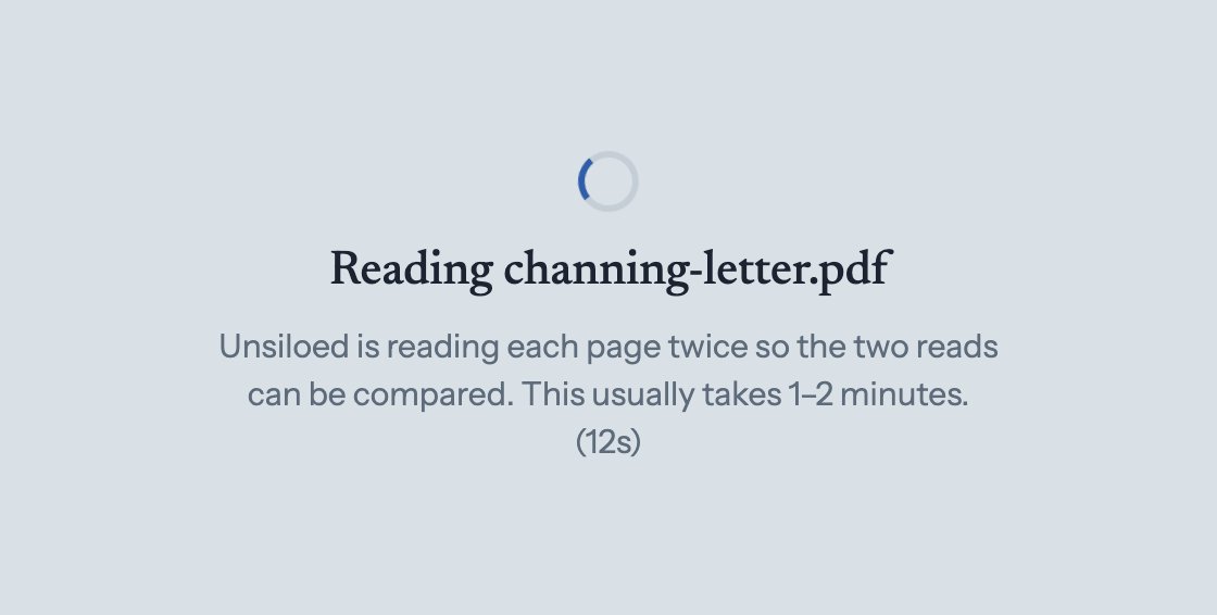 The app while a document is processing: a spinner and the message that Unsiloed is reading the page twice, which usually takes one to two minutes