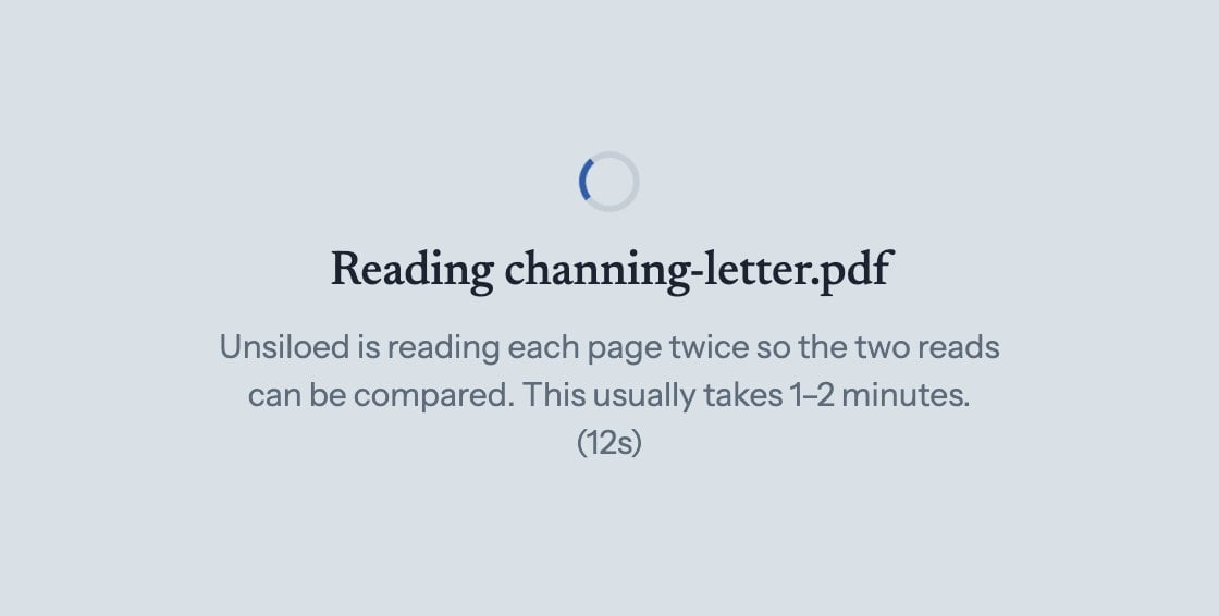 The app while a document is processing: a spinner and the message that Unsiloed is reading the page twice, which usually takes one to two minutes