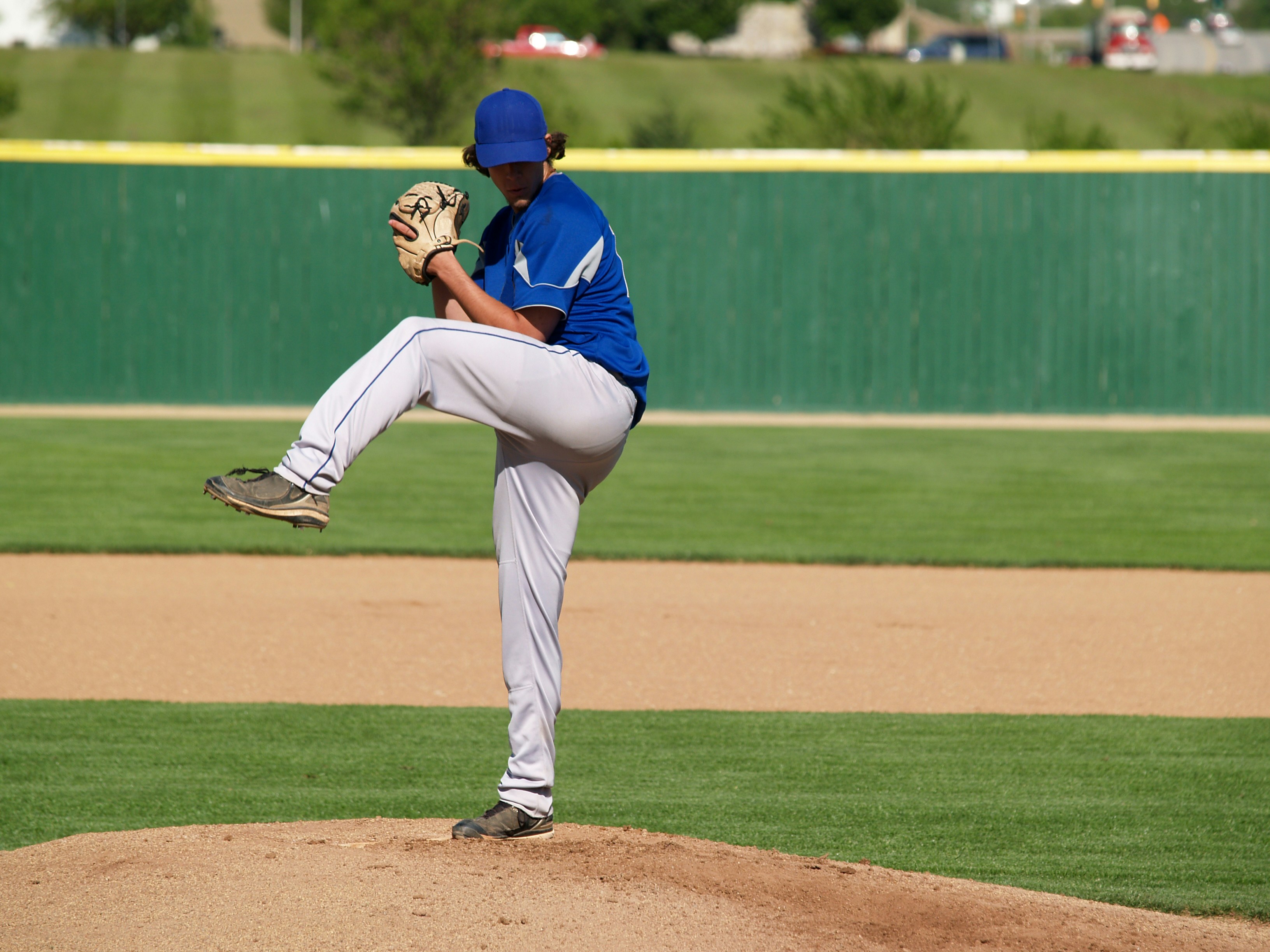Pitcher winding up before delivering a pitch