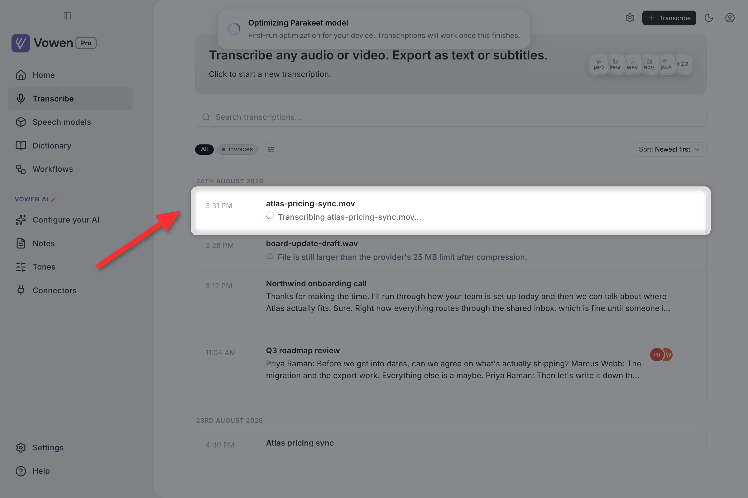 A row on the Transcribe page showing a spinner beside a filename while the file is being transcribed