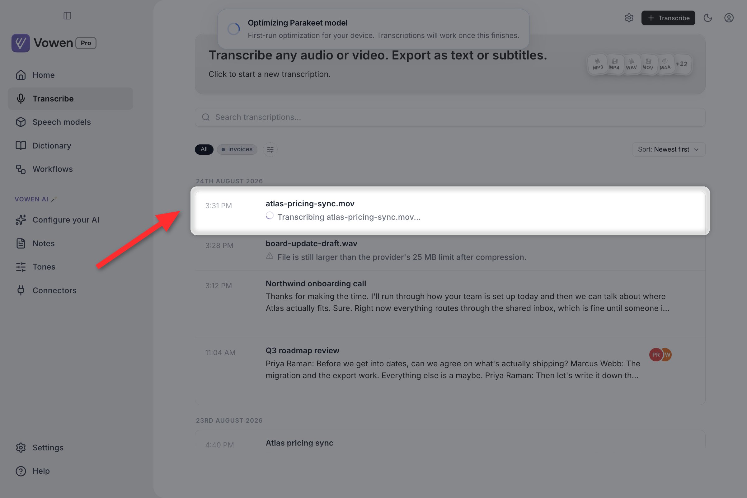 A row on the Transcribe page showing a spinner beside a filename while the file is being transcribed