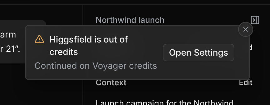 A warning notification titled Higgsfield is out of credits, with the line Continued on Voyager credits and an Open Settings button.