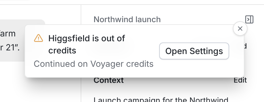 A warning notification titled Higgsfield is out of credits, with the line Continued on Voyager credits and an Open Settings button.
