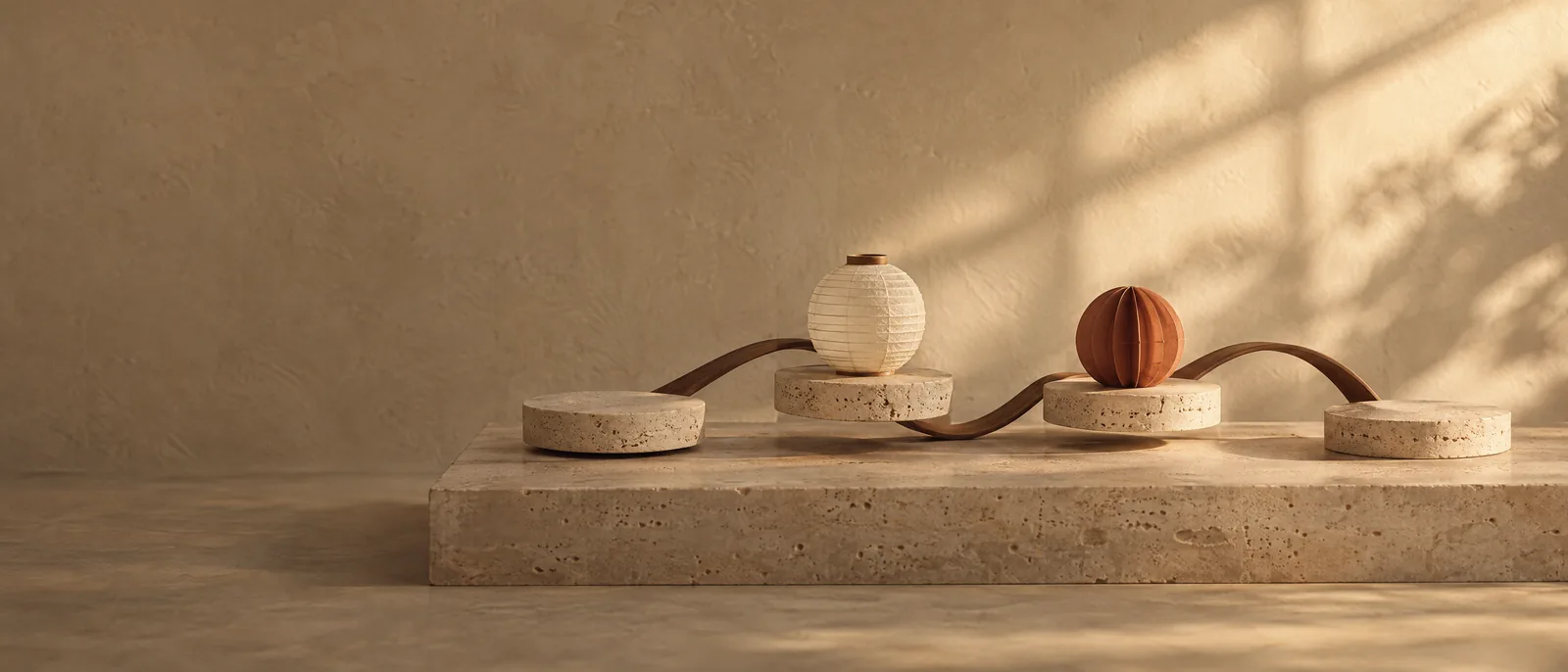 Four stone discs linked by thin bent wooden loops, with a paper lantern on one