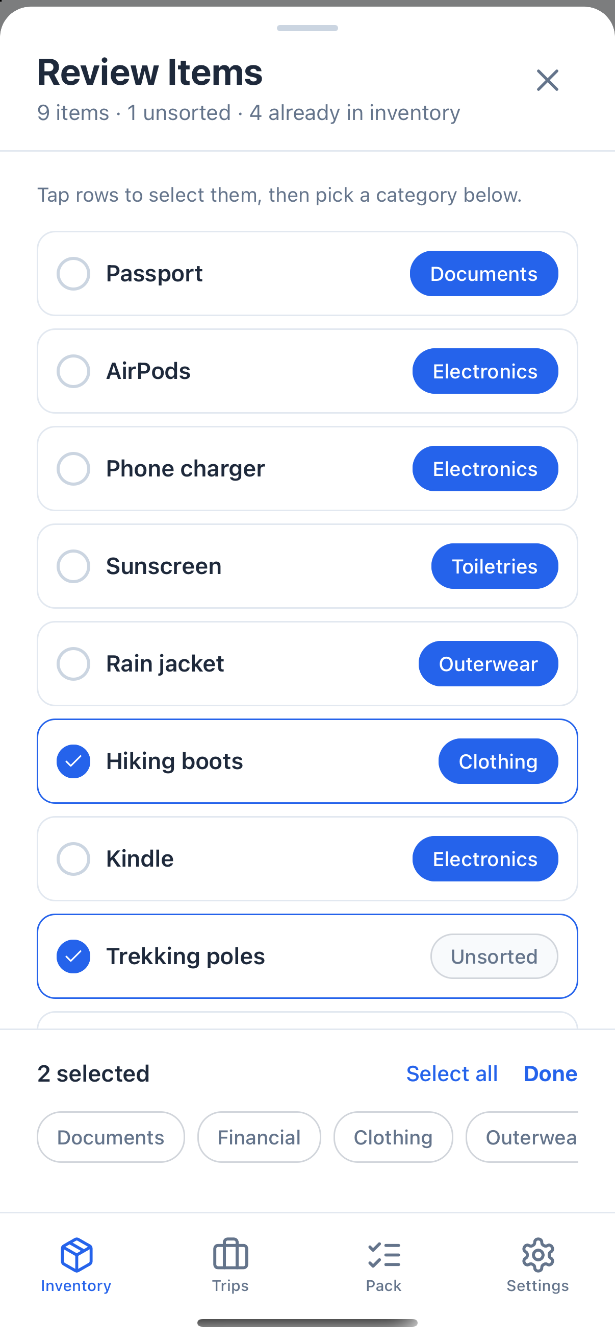 The review screen in select mode. Hiking boots and the Unsorted Trekking poles row are checked. A bar at the bottom reads 2 selected, with Select all and Done, above a row of category buttons.