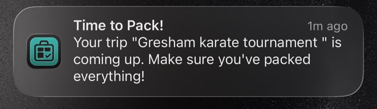 An iOS push notification from PackKit reading 'Gresham karate tournament departs tomorrow' with a body showing current packing progress.