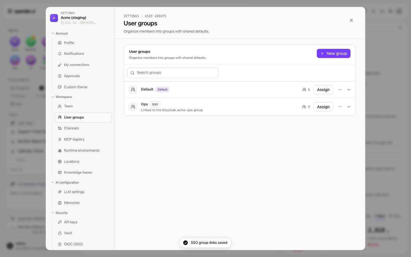 User groups list with a Default group and an Ops group carrying an SSO badge and the line 'Linked to the Keycloak acme-ops group', with a toast reading SSO group links saved